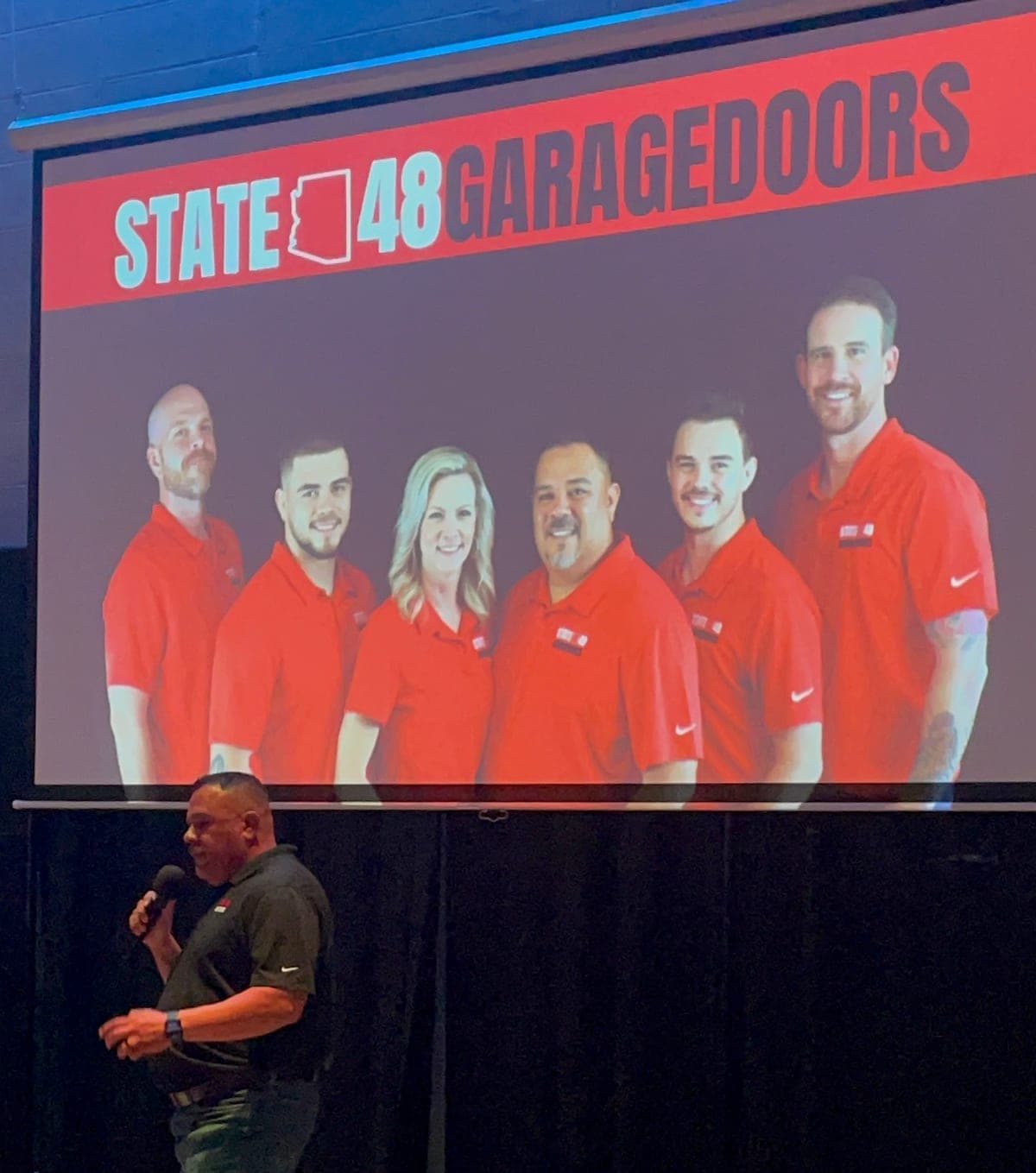A State 48 Garage Doors presentation to the NARPM Phoenix chapter, with the team on screen behind the speaker